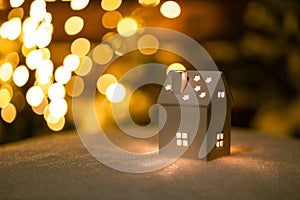 A little house with stars on the snow in the night with boche background.