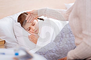 Little ill child sleeping peacefully in her bed photo