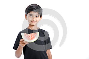 little Indian boy eating watermelon with multiple expressions