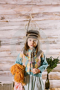 Little indian girl holding a feather in her hands