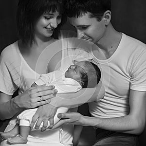 Little infant baby boy sleeping laying on mothers arms. Mother k