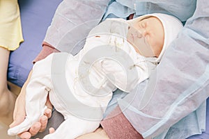 Little infant newborn child in maternity hospital on his fathers