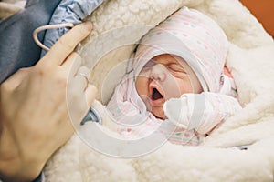 Little infant newborn child in maternity hospital on his mothers