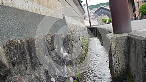 Little irrigation canal ditch running through a village in Japan
