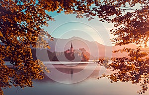 Little Island with Catholic Church in Bled Lake, Slovenia at Sunrise photo