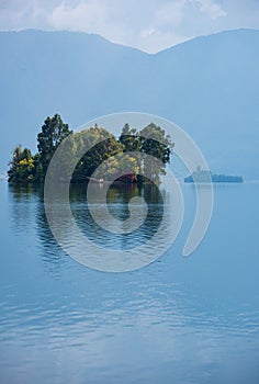 Little island covered with trees in Lugu Lake, Yunnan Sichuan, west China