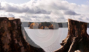 Little island etween two stumps on lake in sunny day. Sosnovo, Leningradskaya oblast, Russia