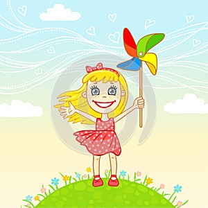 Little joyful girl plays a pinwheel