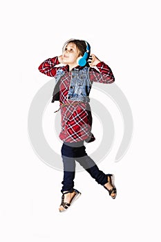 Little jumping caucasian girl with a headphones