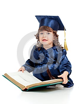 Little kid in academician clothes with book