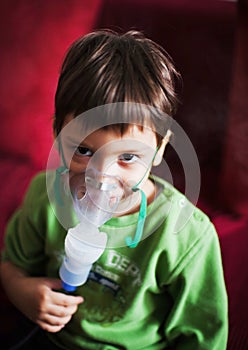 Little kid with aerosols inhaler