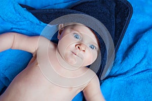 Little kid baby boy against blue bath towel
