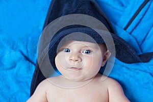 Little kid baby boy against blue bath towel