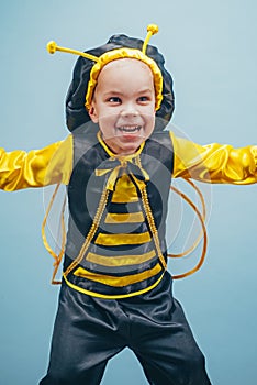 Little kid with a bee costume on carnival. Happy little boy. Close-up. Adorable baby having fun. Funny boy. Happy