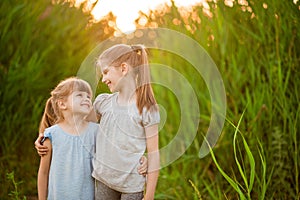 Little kid best friends hugging outdoor at summer