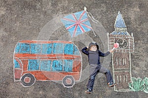 Little kid boy in british policeman uniform with London picture