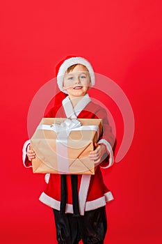 Little kid boy dressed as Santa Claus. Christmas shopping. Christmas present. Childhood. New Year party. Santa Claus baby