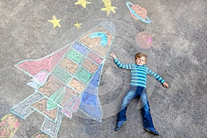 Little kid boy flying by a space shuttle chalks picture