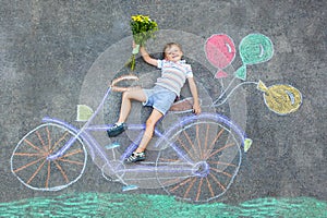 Little kid boy having fun with bike chalks picture