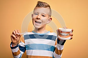 Little kid boy holding professional orthodontic denture with metal braces and removable invisible aligner