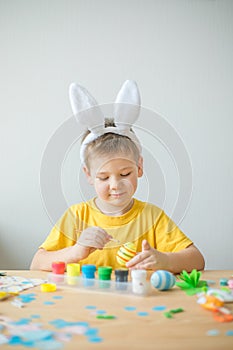 Little kid boy painted  easter egg. DIY  for easter holidays with kids.  Craft for spring