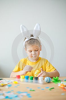 Little kid boy painted  easter egg. DIY  for easter holidays with kids.  Craft for spring