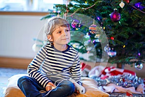 Little kid boy playing video game console on Christmas