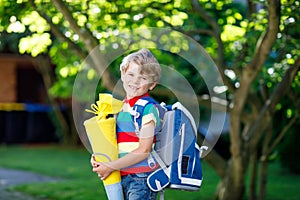 Little kid boy with school satchel on first day to school