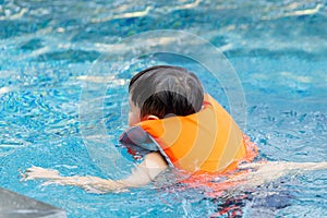 Little kid boy swimming in outdoor pool, kids swimming in pool