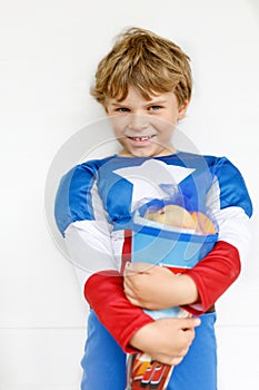 Little kid boy with traditional German school bag in superhero costume