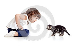 Little kid and cat looking at each other on white