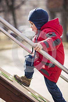Little kid, caucasian boy, having fun in the park