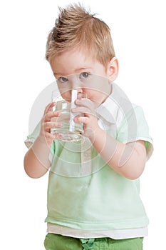 Little kid or child drinking water from glass