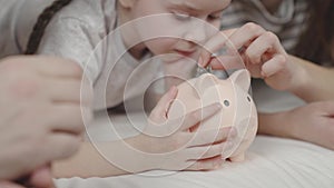 little kid collects cash coins piggy bank, mother father and child happy family, savings for future life, save and keep