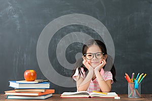 Little kid girl back to school sitting in class