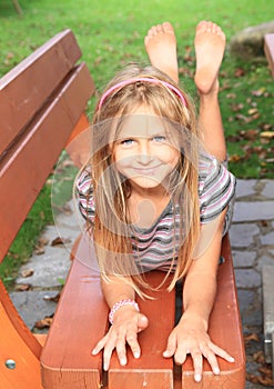 Little kid - girl on a bench