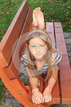 Little kid - girl on a bench