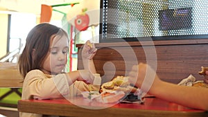 Little kid girl closeup eating, fast food, junk food, Unhealthy diet, fries
