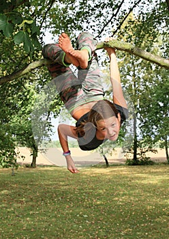 Little kid - girl hanging on branch