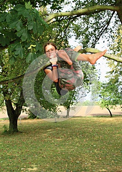 Little kid - girl hanging on branch