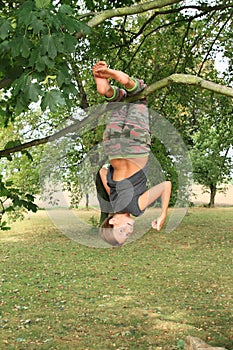 Little kid - girl hanging on branch