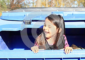 Little kid - girl hiding in a container