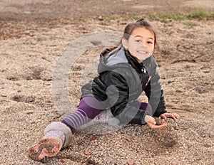 Little kid - girl playing in sand