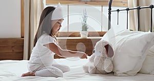 Little kid girl playing with toy as doctor make injection