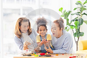 Little kid girl spending happy time with grandma, Child playing toys and game at home with positive senior grandparents in living