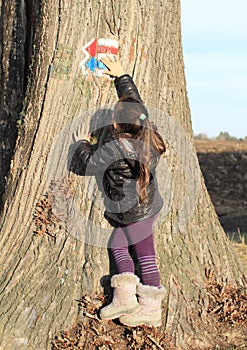 Little kid - girl touching touristic signs