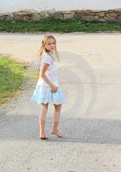 Little kid - girl walking barefoot