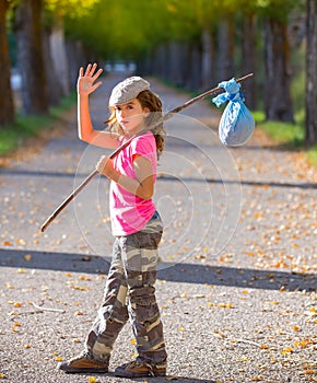 Little kid with hobo stick bag and bundle girl saying goodbye