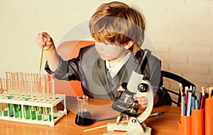 Little kid learning chemistry in school laboratory. kid scientist study science. little boy at lesson. Lovely day in the