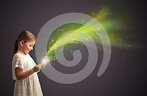 Little kid playing on sparkling tablet